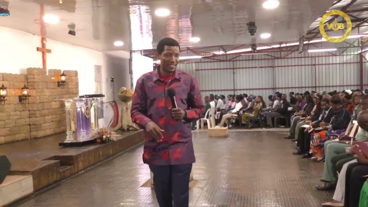 Prophet Promise walking through the VOBI church hall during a service